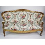 FRENCH STYLE MOULDED GILT WOOD AND GESSO SETTEE, the show wood frame with curved back, scroll arms