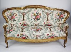 FRENCH STYLE MOULDED GILT WOOD AND GESSO SETTEE, the show wood frame with curved back, scroll arms