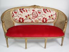 MOULDED AND CARVED GILT WOOD FRAMED FRENCH THREE SEATER SETTEE, with floral cresting, curved ends