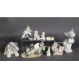 NINE LLADRO PORCELAIN MODELS OF CATS AND DOGS, including a cat modelled with flowers and another