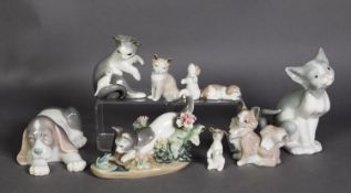 NINE LLADRO PORCELAIN MODELS OF CATS AND DOGS, including a cat modelled with flowers and another