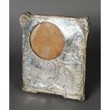 EDWARD VII ARTS AND CRAFTS EMBOSSED SILVER FRONTED PHOTOGRAPH FRAME, with oak back and easel