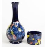 TWO PIECES OF WALTER MOORCROFT CLEMATIS PATTERN TUBE LINED POTTERY ON BLUE GROUNDS, comprising: