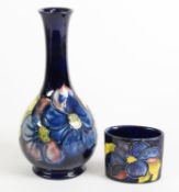 TWO PIECES OF WALTER MOORCROFT CLEMATIS PATTERN TUBE LINED POTTERY ON BLUE GROUNDS, comprising: