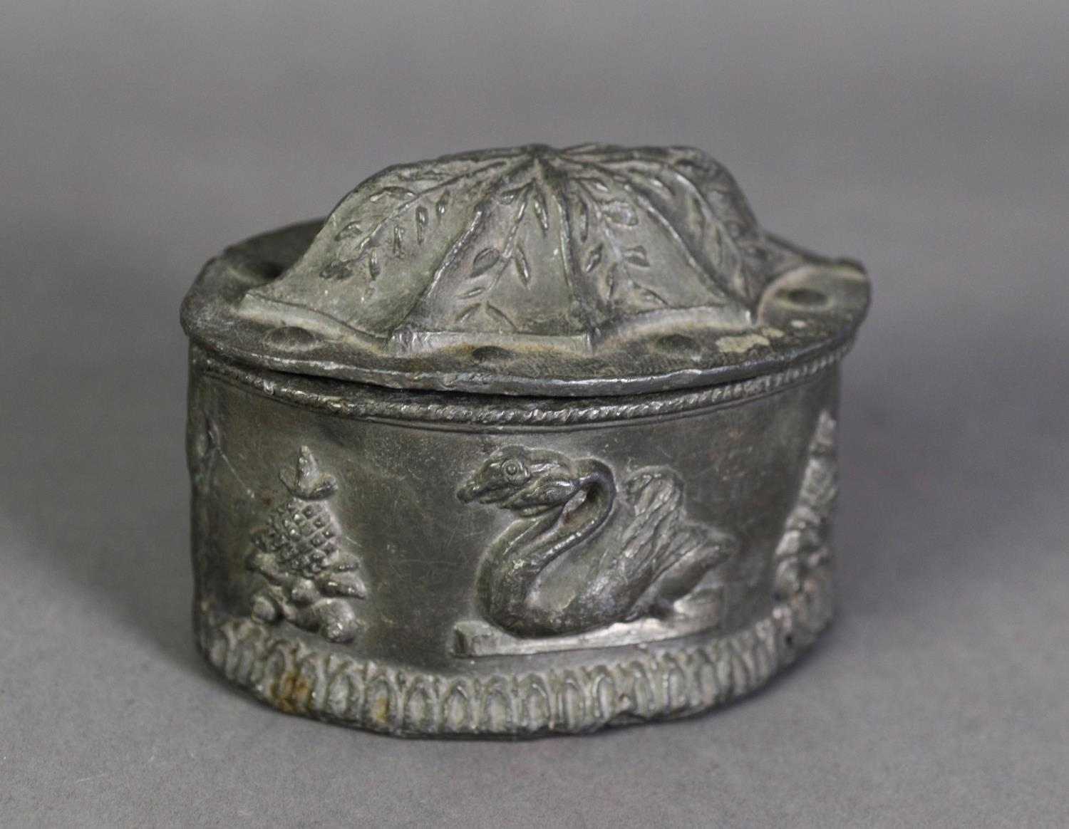 NINETEENTH CENTURY LEAD TOBACCO BOX AND COVER, of elliptical form, the sides embossed with