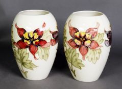 PAIR OF WALTER MOORCROFT ‘COLUMBINE’ PATTERN TUBE LINED POTTERY VASES, each of ovoid form, painted