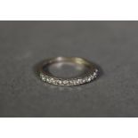18ct WHITE GOLD RING SET WITH A HOOP OF 11 SMALL DIAMONDS, approximately .22ct in total, 1.5gms