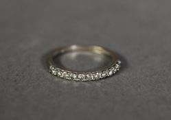 18ct WHITE GOLD RING SET WITH A HOOP OF 11 SMALL DIAMONDS, approximately .22ct in total, 1.5gms