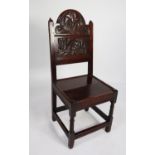 EIGHTEENTH CENTURY CARVED OAK SIDE CHAIR, the panelled back with arced top, carved in relief with