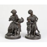 A PAIR OF 19TH CENTURY SPELTER FIGURE GROUPS OF CHILDREN PLAYING, one in roman dress, 11 ¼” (28.5