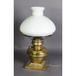 EARLY TWENTIETH CENTURY BRASS AND MILK GLASS OIL TABLE LAMP, of squat form with square base and