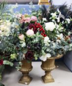 PAIR OF GILT PLASTIC PEDESTAL URN SHAPED ARTIFICIAL FLOWER VASES WITH DISPLAYS, one quite sparse,