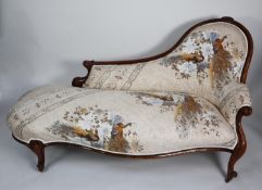 VICTORIAN CARVED WALNUT FRAMED CHAISE LONGUE, the moulded show wood frame enclosing an arched back