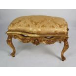FRENCH STYLE CARVED GILT WOOD LARGE FOOTSTOOL OR SEAT, of serpentine outline with olde gold