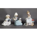 THREE LLADRO PORCELAIN GROUPS OF GIRLS WITH DOGS, printed marks, 7 ½” (19cm) high and smaller, (3)