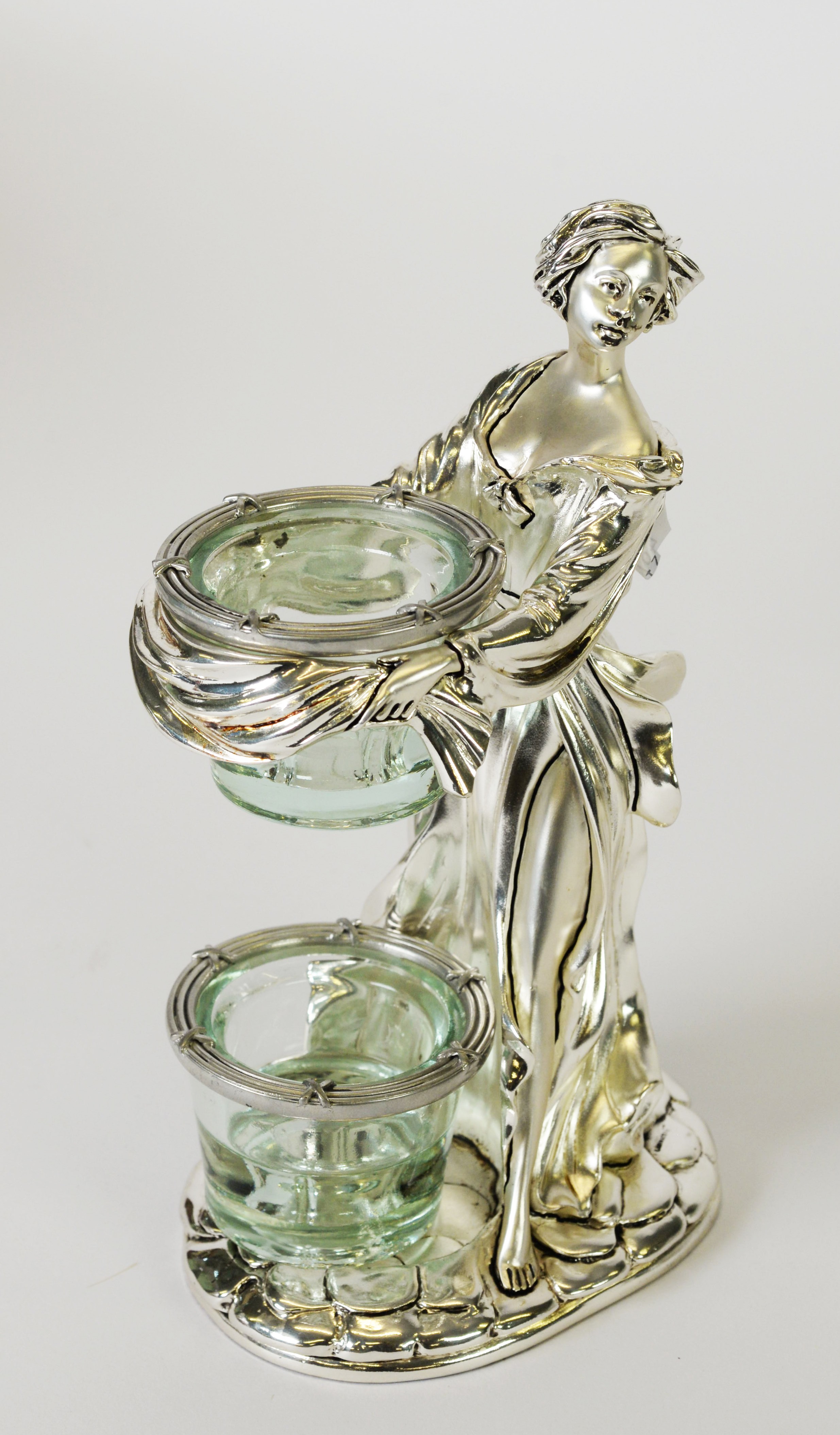 ITALIAN ‘LAMINATO’ CASED SILVER COLOURED METAL FEMALE FIGURAL CANDLE HOLDER, modelled standing