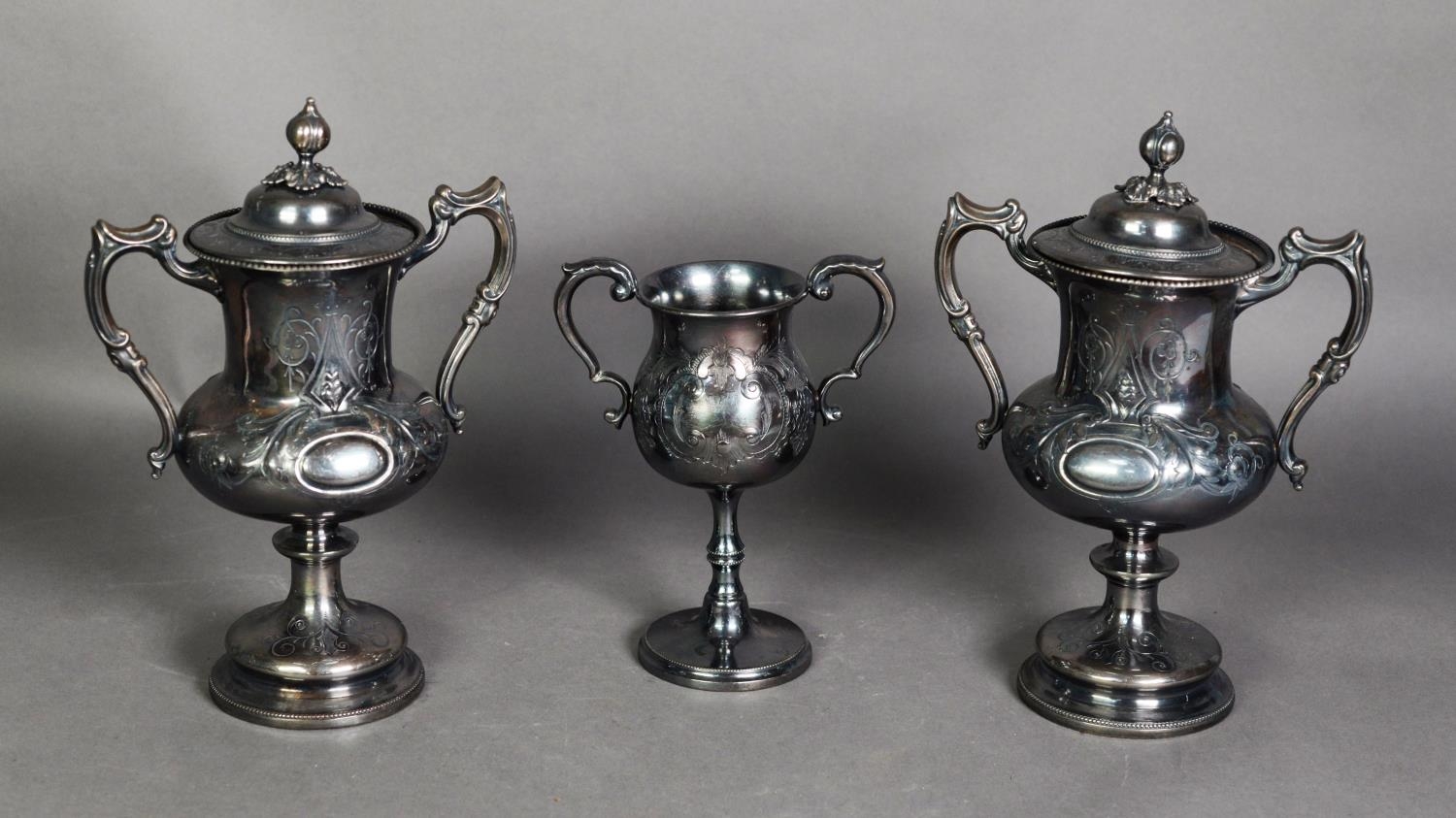 PAIR OF LATE 19th/EARLY 20th CENTURY EPBM TWO HANDLED TROPHY CUPS AND COVERS, with foliate scroll