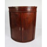 UNUSUAL EARLY NINETEENTH CENTURY FIGURED MAHOGANY VENEERED ON OAK CARCASE BOW FRONTED CORNER