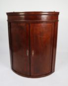 UNUSUAL EARLY NINETEENTH CENTURY FIGURED MAHOGANY VENEERED ON OAK CARCASE BOW FRONTED CORNER