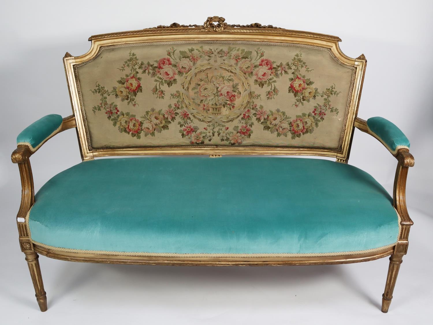 FRENCH STYLE MOULDED GILT WOOD SETTEE, the show wood frame with shaped oblong back open arms with