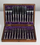 EARLY 20th CENTURY WALKER & HALL BOXED SET OF TWELVE PAIRS OF PLATED METAL FISH EATERS with double