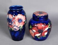 TWO PIECES OF WALTER MOORCROFT ‘ANENOME’ PATTERN TUBE LINED POTTERY ON DARK BLUE GROUNDS,