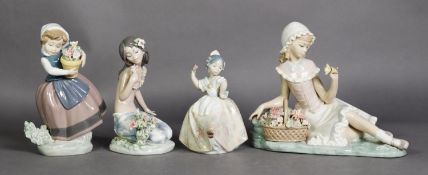 FOUR LLADRO PORCELAIN MODELS OF YOUNG GIRLS WITH FLOWERS, printed marks, 6 ½” (16.5cm) high and
