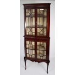 EDWARDIAN LINE INLAID MAHOGANY DOUBLE CORNER CUPBOARD enclosed by four astragal glazed doors, on