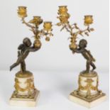 A PAIR OF LATE 18TH CENTURY NEO-CLASSICAL PARCEL GILT BRONZE CANDELABRUM, modelled as winged putti