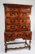 ANTIQUE FIGURED WALNUT CHEST ON STAND, the moulded cornice above two short and three long drawers