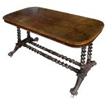 A Victorian walnut stretcher table on barley twist supports