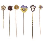 An enamel pansy diamond set stick pin together with five others