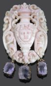 A Victorian carved angel skin coral classical scroll cameo brooch