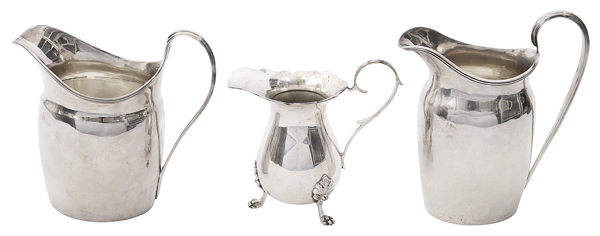 A George III silver cream jug and two others in Georgian style