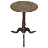 An early 19th century small oak tripod wine table