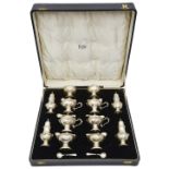 A George V silver twelve piece silver cruet set retailed by Finnigans
