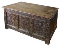 An 18th century and later oak coffer carved with thistles