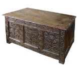 An 18th century and later oak coffer carved with thistles