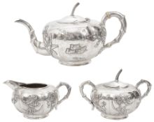 An early 20th century Chinese export silver three piece tea service marked for Kwan Wo