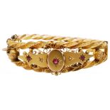 A Victorian 9ct gold Etruscan style ruby and diamond set bangle