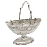 A late Victorian silver swing handled sugar basket