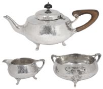 An Arts and Crafts silver three piece tea service