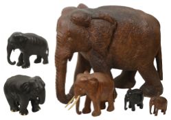 A large 19th century palm wood elephant together with five smaller elephants