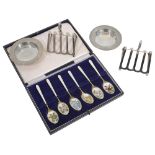 A pair of George V Asprey silver toast racks and pin dishes,