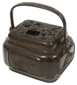 A large 19th century Chinese patinated bronze hand warmer