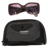 A pair of Chanel sunglasses and make up bag