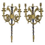 A pair of French Louis XVI style gilt bronze twin light appliques after Pierre Gouthiere