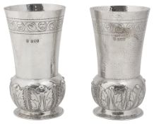 A pair of late Victorian Arts and Crafts silver vases