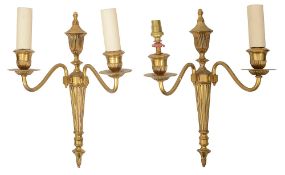A pair of Edwardian gilt brass twin light wall appliques