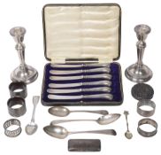 A collection of silver to include a pair of George V candlesticks, other silver
